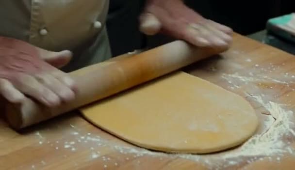 Still from a MiniMax H3 cooking clip used as a hand-topology failure example